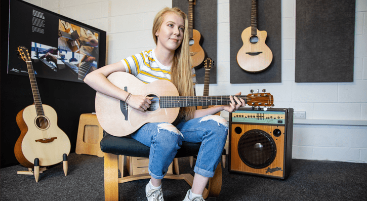 Hannah singing with guitar